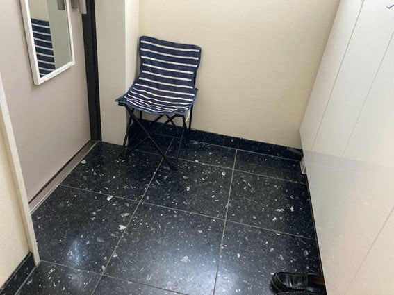 キャンプ用のいすを玄関のすみに置いている