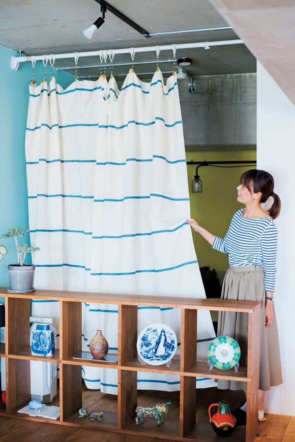 女性カーテンをひっぱる