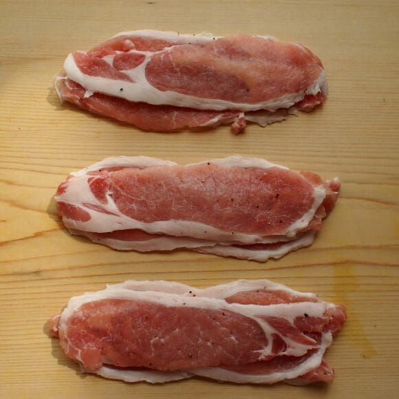 （1）　豚肉に塩コショウをふり、5枚ほど重ねる。