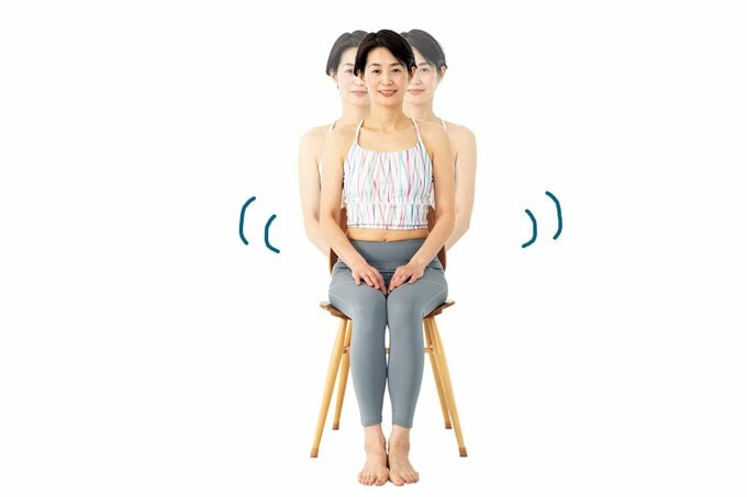 椅子に座って左右に揺れる女性