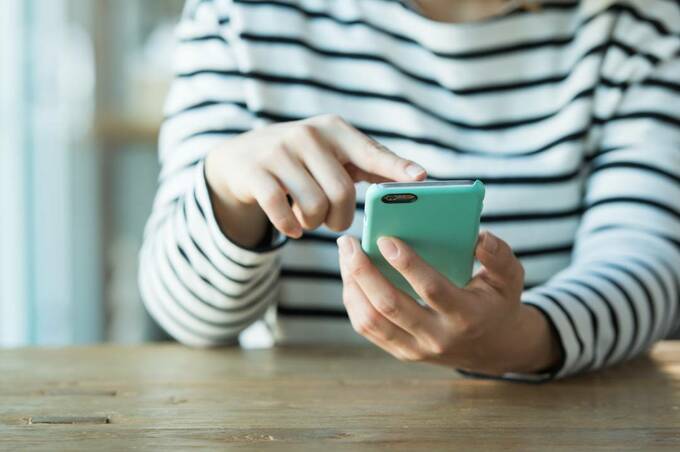 緑のスマホを持つ様子