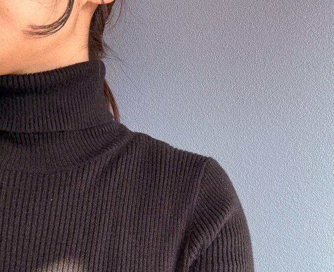 タートルネックセーターを着る女性の首元