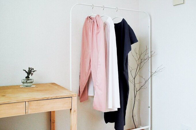 洋服をハンガーラックに掛けている様子