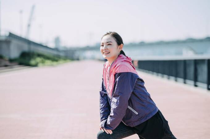 外でストレッチをする女性