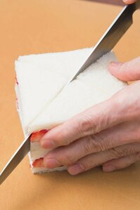 （4）（3）を2つつくり、それぞれ耳を落としたら、包丁をゆっくり動かし対角線で切って各4等分にする