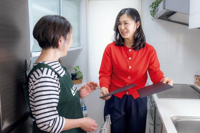 ハウスキーパーにまな板を見せる女性