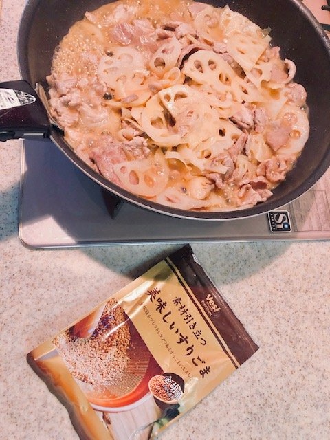 フライパンにレンコンと豚バラの隣にすりごま