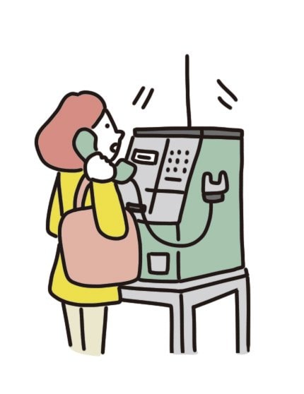公衆電話を使う女性
