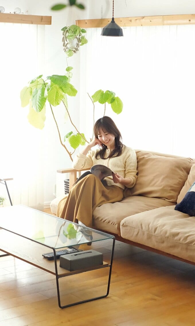 ソファに座り雑誌を読む女性