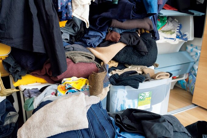 透明収納ボックスの上にたくさんの衣類