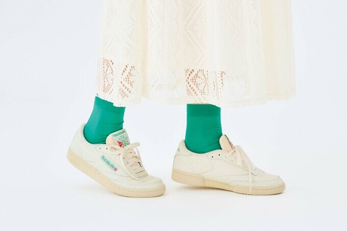 白スニーカーとグリーンソックスを履いた足元