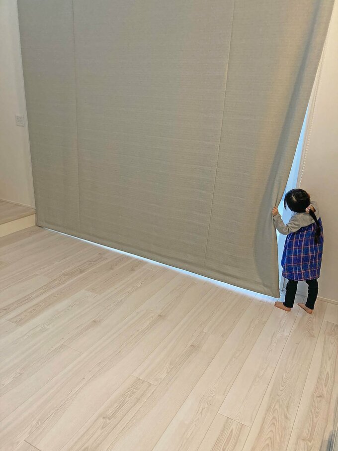 シェードカーテンから外を覗く様子