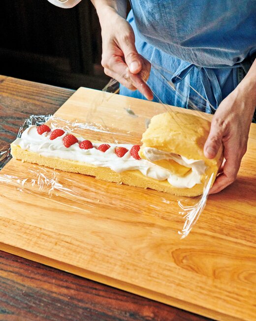 ケーキ生地をロール状に巻いているところ