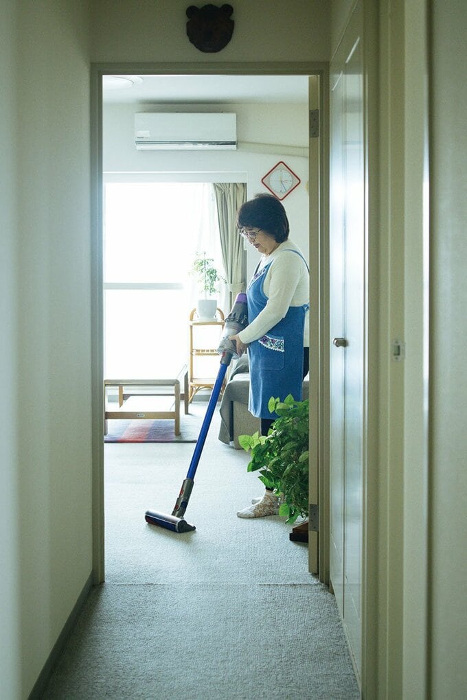 掃除機をかける足立洋子さん