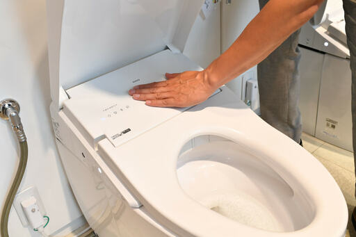 便座前方に手を置く様子