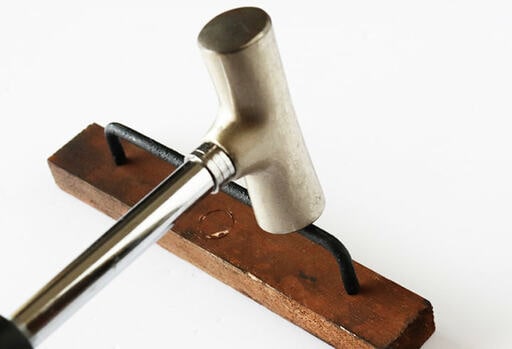 端材に鎹を打ち込む