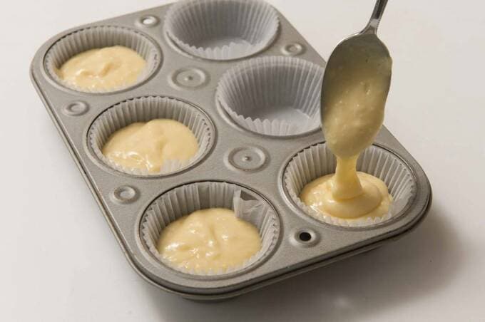 グラシン紙を敷いた型にスプーンで生地を入れる