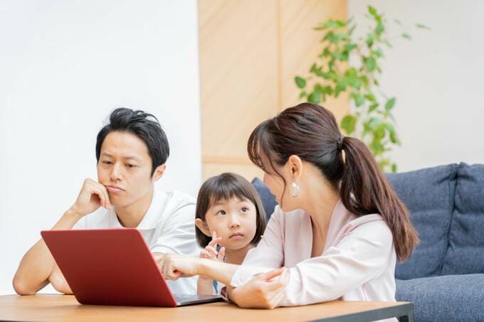パソコンの前に男女と子ども