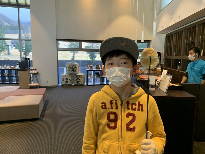 焼けたおせんべいを持つ子ども