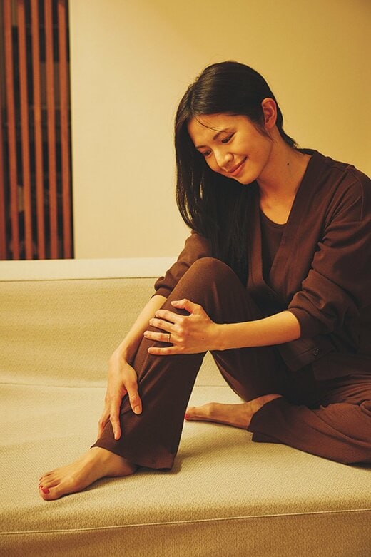 足に触れる女性