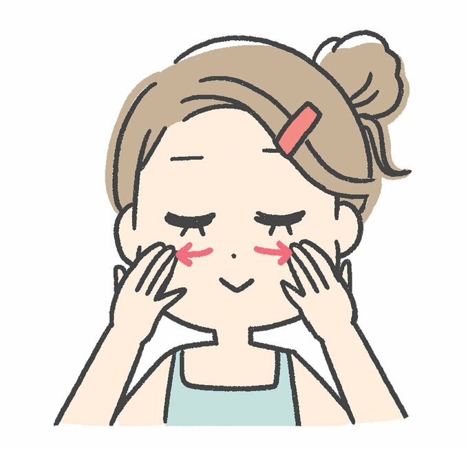 中3本の指の腹で顔の中心から外側へ伸ばす様子