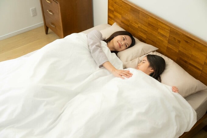 ベッドで寝ている親子