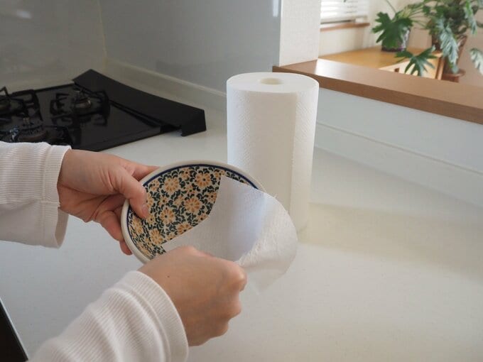 キッチンタオルで皿を拭く