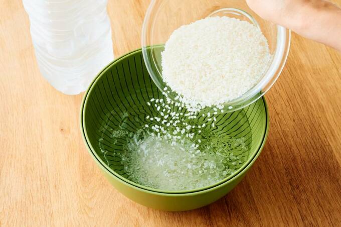 水を張ったボウルにお米を入れる