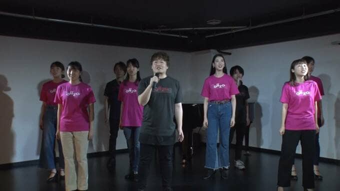 ステージ中央で歌う男性と女性