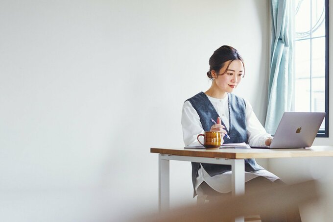 座ってパソコン作業をする女性