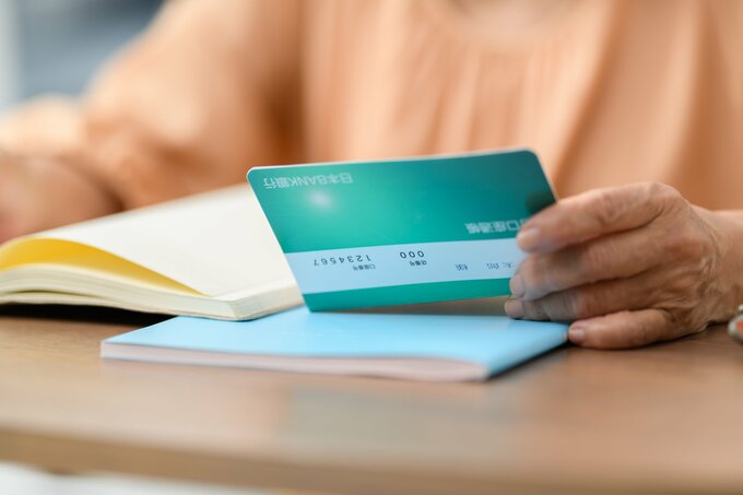 通帳を持つ女性