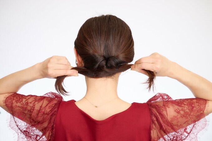 左右に毛束を引っぱる女性