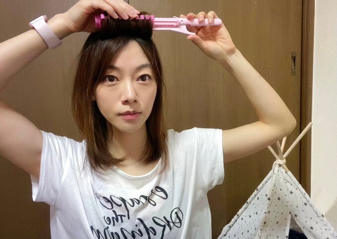 カーラーを外す女性