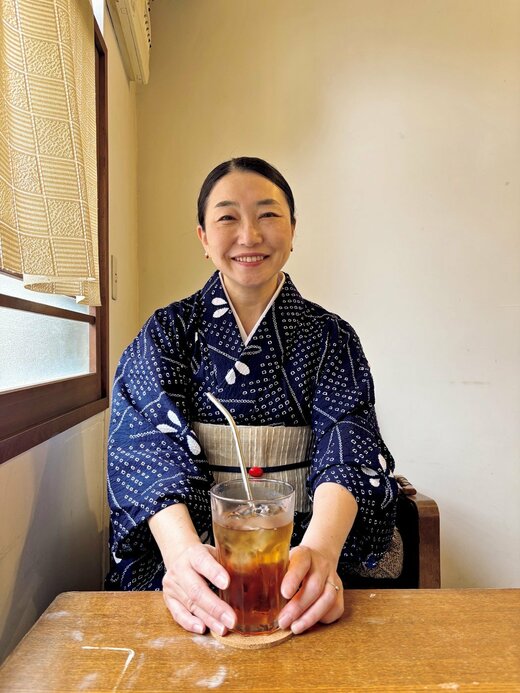 着物を着た女性がグラスに入った冷たい麦茶に手を置く姿