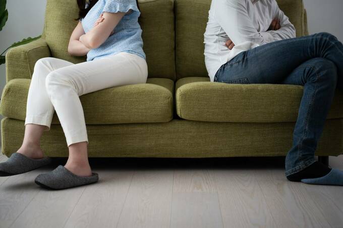 背中合わせでソファに座る様子