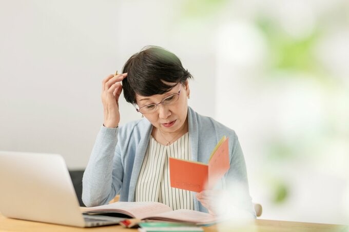 通帳を見る女性