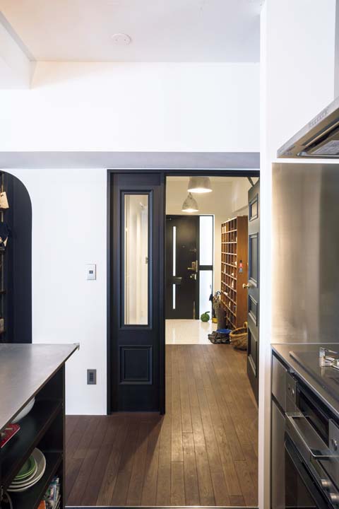 キッチンから造作の扉越しに玄関を見たところ