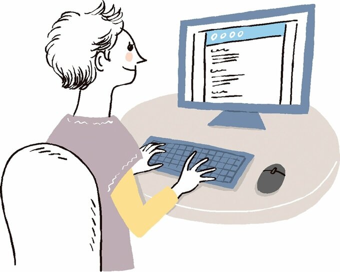 パソコンで調べ物をする人物