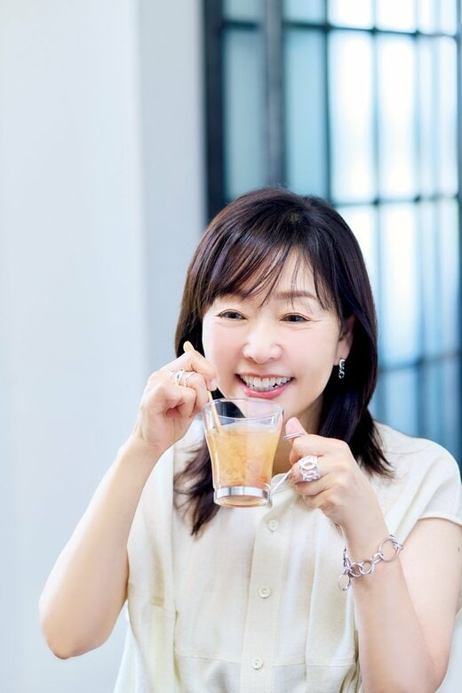 飲み物の入ったコップを持つ女性