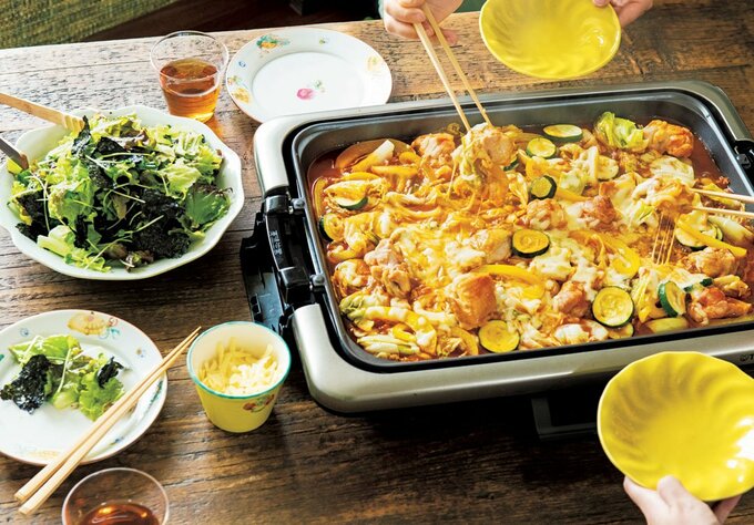 ホットプレートのチーズタッカルビを箸でつつく