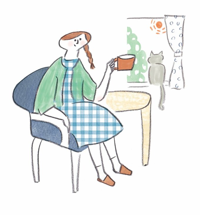 窓辺でリラックスしている女性と猫