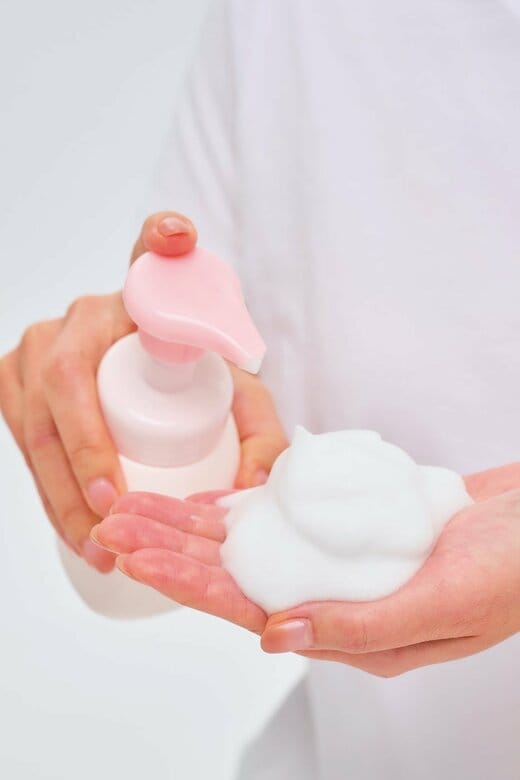 洗顔料を手のひらに出している人