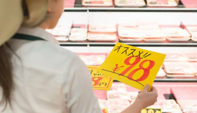 値札を持つ女性の画像