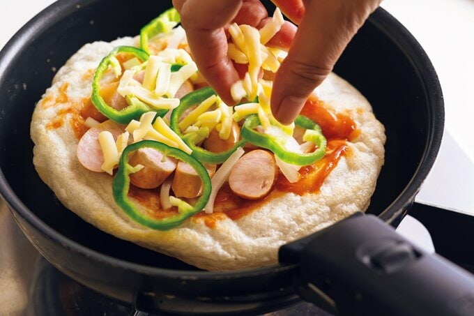 もちピザにチーズを追加していく様子