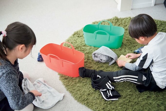 子どもが服をたたむ様子