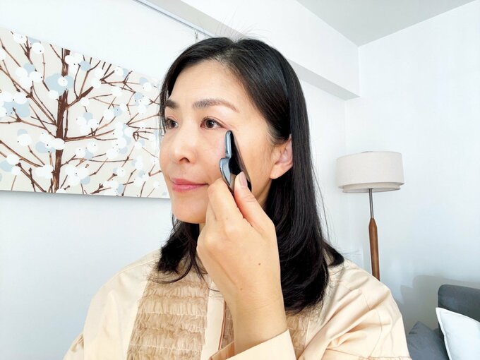 かっさを頬にあてる女性