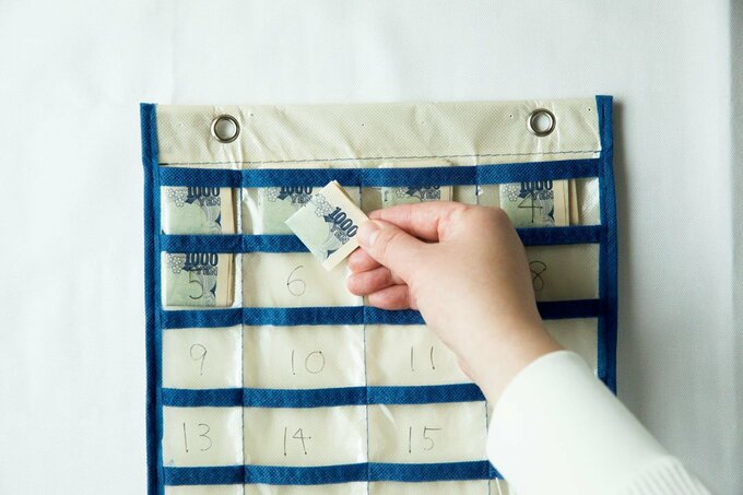 ウォールポケットにお札を入れる様子