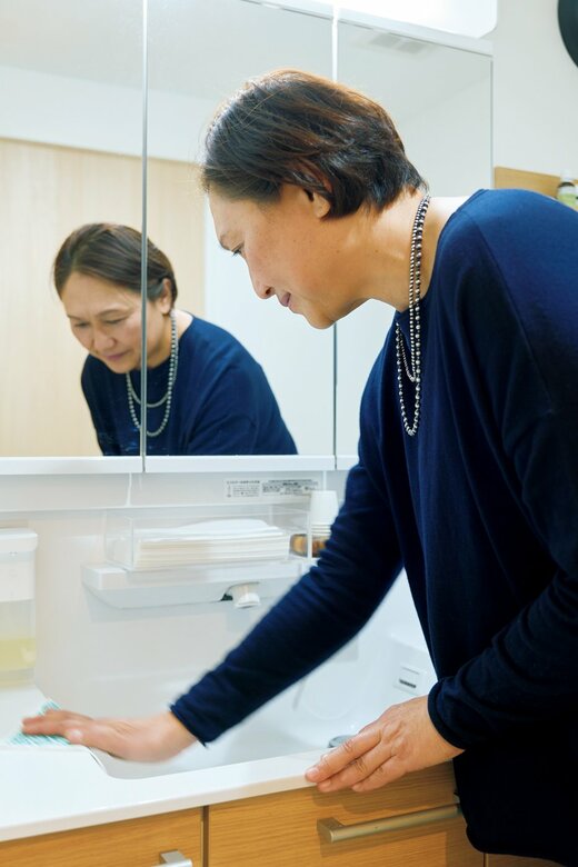 洗面台をふき上げる五味さん