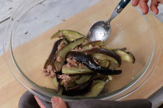 加熱したナスとツナを和える様子