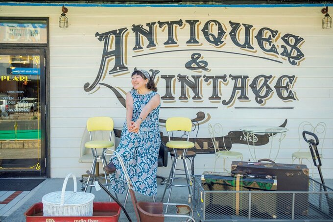 ヴィンテージ家具店「PEARL.」の前で椅子に座る枝元さん